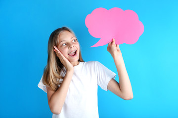 Young girl holding speech bubble on blue background