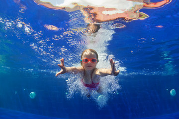 Happy family in swimming pool. Smiling child in goggles swim, dive in pool with fun - jump deep down underwater. Healthy lifestyle, people water sport activity, swimming lessons on holidays with kids - obrazy, fototapety, plakaty
