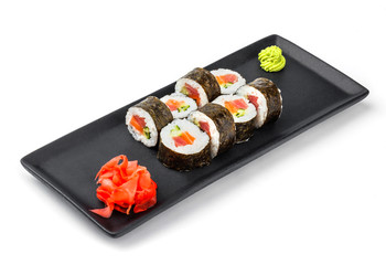 Sushi Roll - Maki Sushi with cucumber, avocado, salmon and cream cheese on black plate isolated over white background. Japanese cuisine