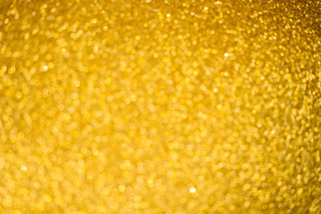 Christmas festive glittering defocused abstract golden background with bokeh lights