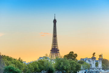 Fototapeta na wymiar Eiffel Tower on Park Champ de Mars at sunset in Paris, France