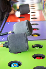 Padded mallet on a carnival whacking game