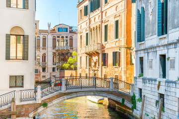 Fototapety  Morning in Venice street with canal, bridge, boats and gondolas
