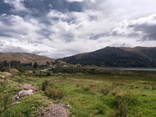 trees and bushes near lagoon, distant mountains, cloudy sky in the background, location acomayo,...