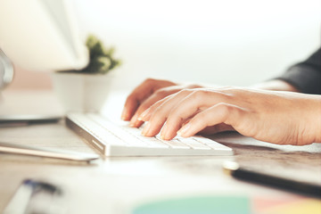 Woman hand typing on computer keyboard