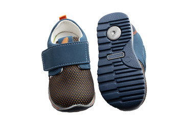 Child shoe fashion. A pair of blue denim child sneaker or sport shoes isolated on a white background. Elegant and trendy shoes.