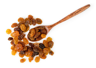 Raisin in a wooden spoon on a white. The view from the top.