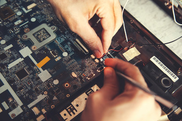 Man hand laptop disassembling