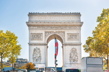 Fototapeta na wymiar Arc de Triomphe with sun on blue sky, in Paris France