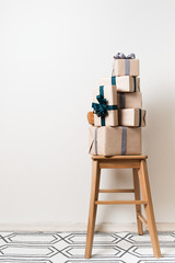 Scandinavian minimalism christmas and new year concept - gift box on a chair in room