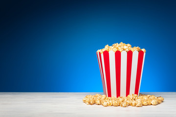 Colorful striped bucket of crispy popcorn