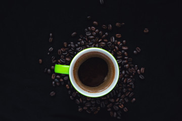 Obraz na płótnie Canvas cup of coffee with beans on black background