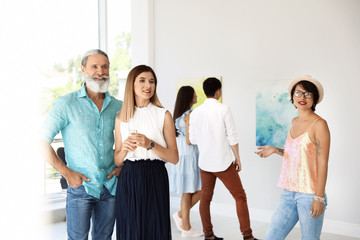 Group of people at exhibition in art gallery