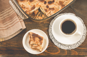 breakfast with apple pie and a cup of black coffee/breakfast with apple pie and a cup of black coffee on a wooden background, top view