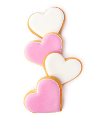 Decorated heart shaped cookies on white background, top view