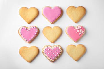 Naklejka na ściany i meble Decorated heart shaped cookies on white background, top view