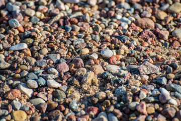 rock covered beach in countryside in Latvia, large rocks in water