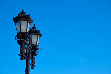 Fototapeta na wymiar Streetlamp on the background of blue sky