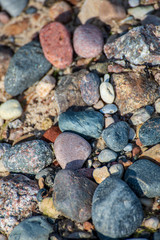 rock covered beach in countryside in Latvia, large rocks in water