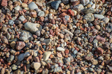 rock covered beach in countryside in Latvia, large rocks in water
