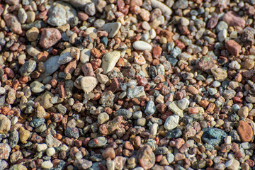 rock covered beach in countryside in Latvia, large rocks in water