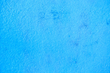 The texture of thin layer of ice or snow colored in blue, background