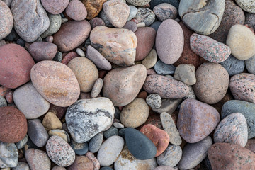 rock covered beach in countryside in Latvia, large rocks in water
