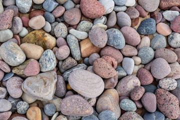 rock covered beach in countryside in Latvia, large rocks in water