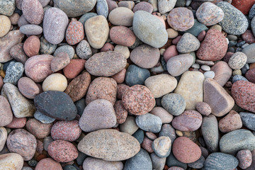 rock covered beach in countryside in Latvia, large rocks in water