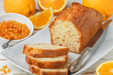 Homemade orange fruit loaf cake with citrus candied fruits and nuts.  Traditional treat for tea for...