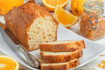 Homemade orange fruit loaf cake with citrus candied fruits and nuts.  Traditional treat for tea for...
