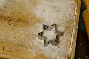 Making Gingerbread Cookies Series. Cutting dough sheet into shapes.