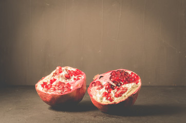Ripe and juicy pomegranate on rustic dark background/Ripe and juicy pomegranate on rustic dark background, selective focus
