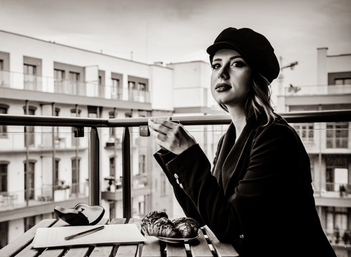 Beautiful young businesswoman have a coffee break while sitting outdoors at home. Concept of work with startup business . Image in black and white color style