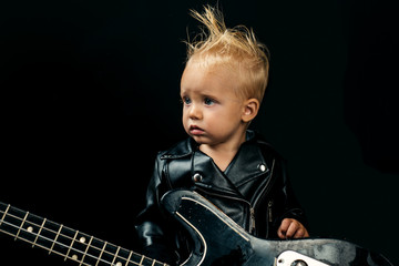 Never stop rock and roll. Small musician. Little guitarist in rocker jacket. Little rock star....
