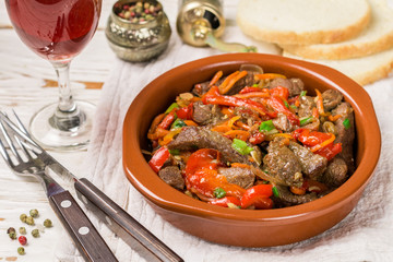 Beef stewed with vegetables-carrots, bell peppers, onions, garlic and spices in ceramic form. A delicious gourmet dinner.  Selective focus