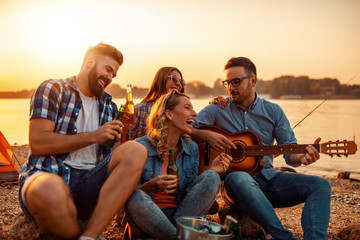 Friends having fun on the beach at night