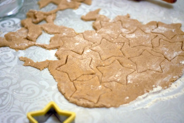 rolled dough with cut out figures for baking cookies