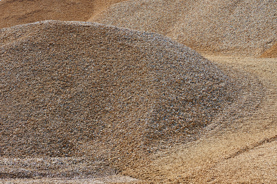 Heaps of sand or macadame and road in a quarry