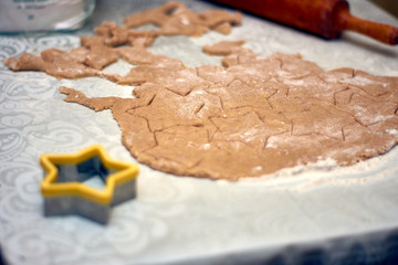 rolled dough with cut out figures for baking cookies
