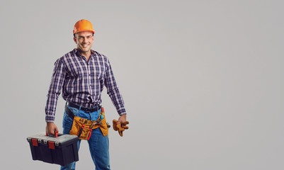 Repairman smiling in special clothes with tools.