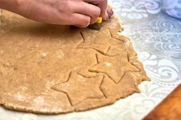 rolled dough with cut out figures for baking cookies