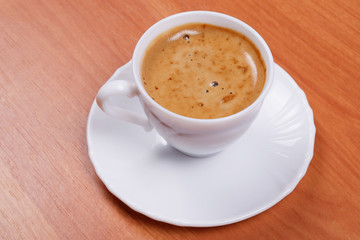 Cup of coffee on wooden table.