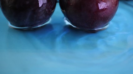 Red yellow apple under water with a trail of transparent bubbles at blue background. Slow motion water splashing concept - Powered by Adobe
