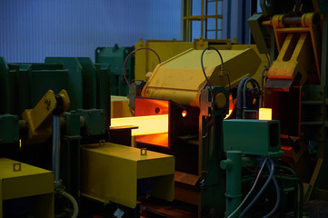 Iron factory with hot candent block of iron or steel or zinc in process of production