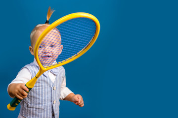 Cute and energetic. Little sport lover. Adorable little child with tennis racket. Active happy...