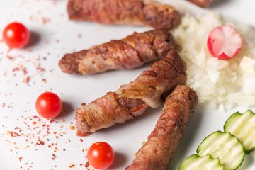 kebab meal on white plate with cherry tomato. fresh fast food meal.
