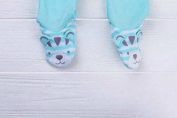 Footed blue baby pajamas legs.