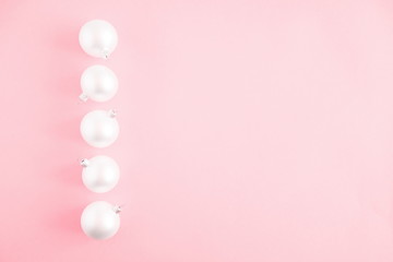 Christmas elegant modern composition. Frame made of white balls and decorations on pastel pink background. Christmas, New Year, winter concept. Flat lay, top view, copy space