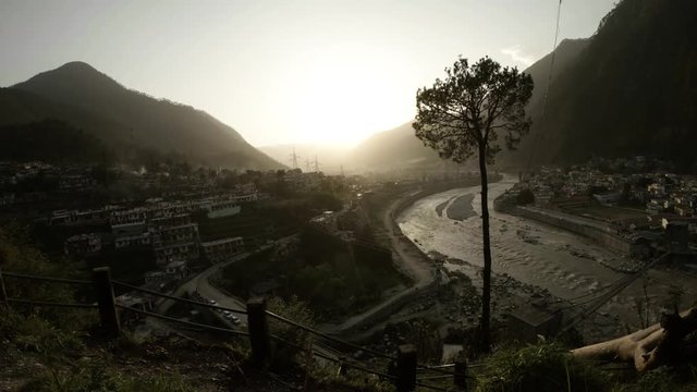 Small mountain town river Ganges flows smoke high pine sunset timelapse